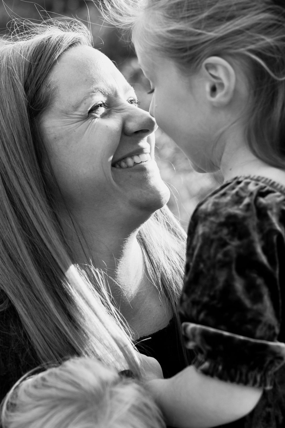 Mother and daughter touching noses together smiling - lifestyle family photographer in Farmington Hills, Michigan.