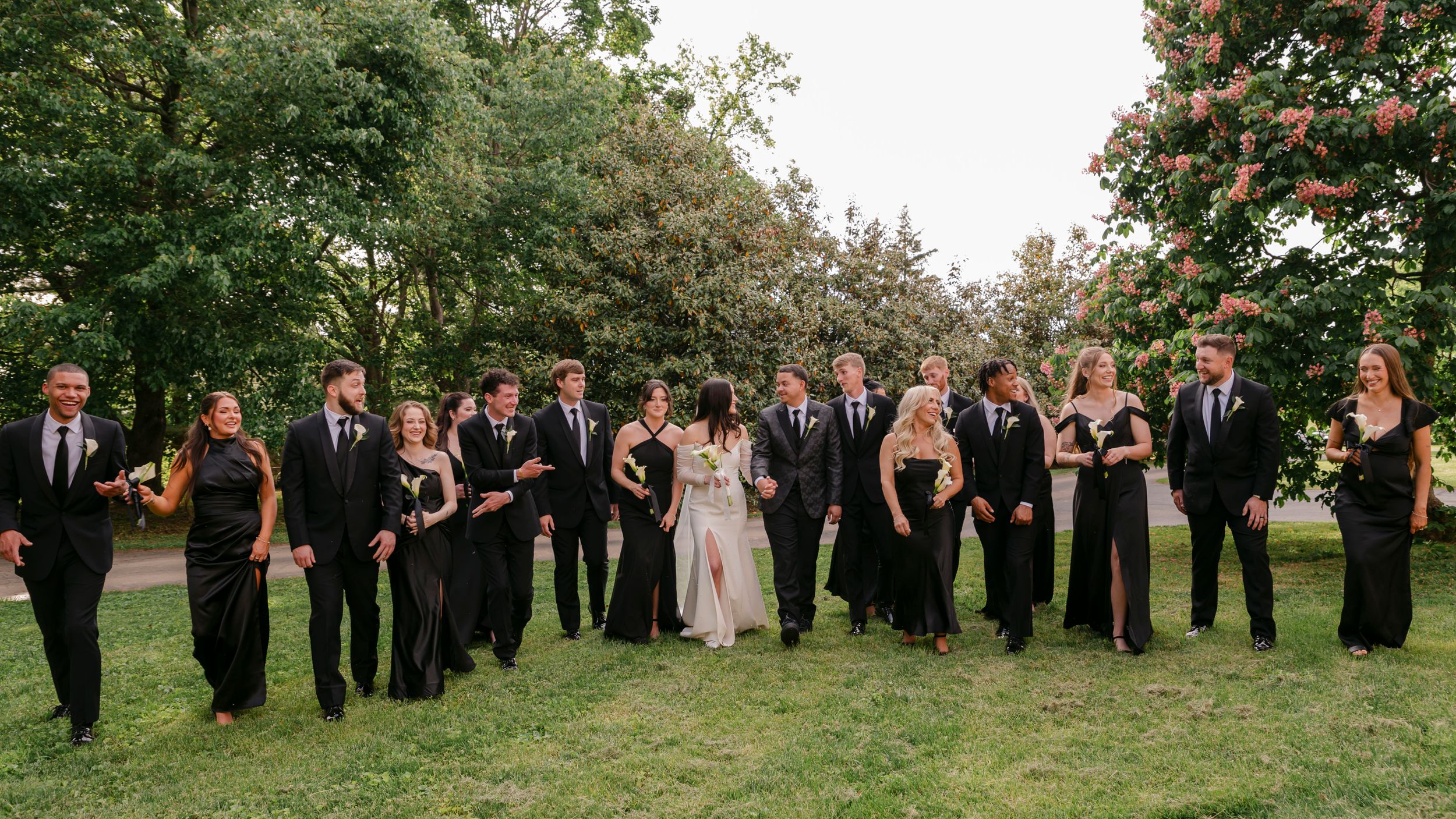 Wedding party smiling and celebrating with bride and groom at Village View Farm in Lexington KY, spring outdoor wedding portrait.