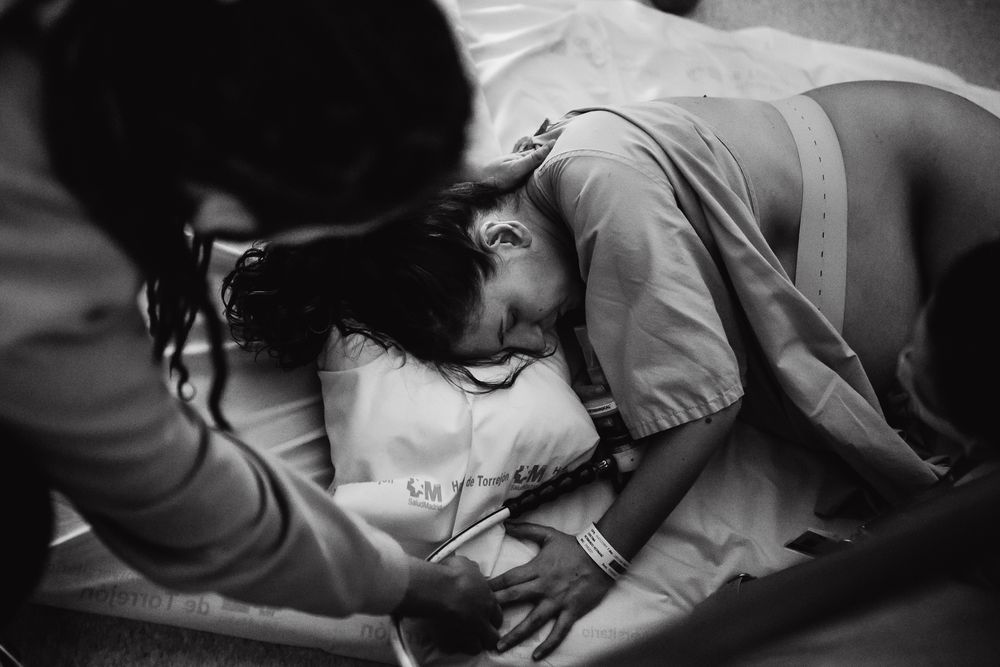Black and white image showing medical professionals in a clinical setting.