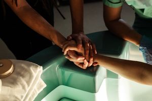 Healthcare providers work together during a medical procedure in a clinical setting.