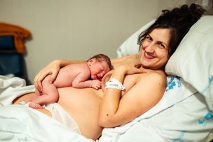 Peaceful moment of bonding in hospital setting with natural lighting.