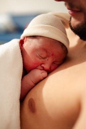 Close-up view of newborn resting during skin-to-skin contact.