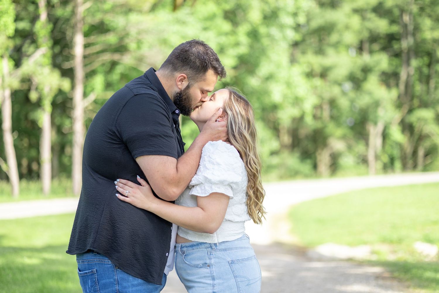 Springfield, IL photographer captures a couple kissing on a trail during a session in Central, IL