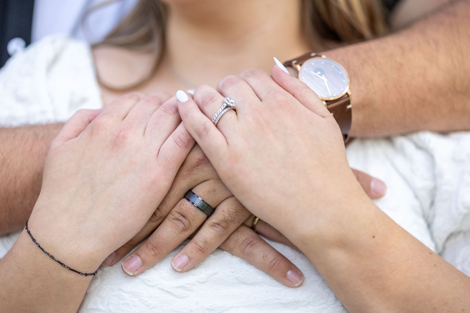 Springfield, IL photographer captures a married couples rings and they snuggle together during a session in Central, IL