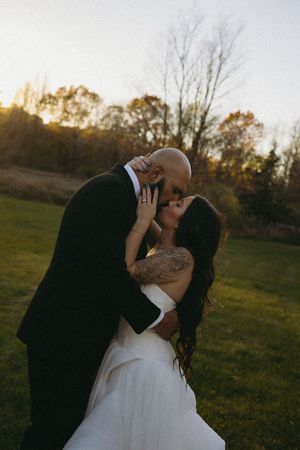 A couple shares a kiss during their November wedding bridal portraits.