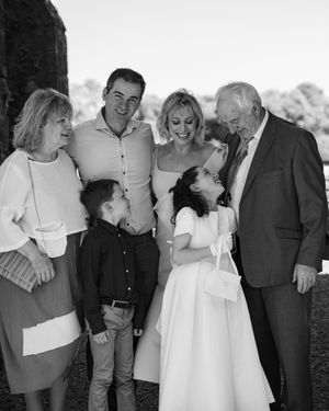 Black and white wedding party photos showing joyful group interactions outdoors.