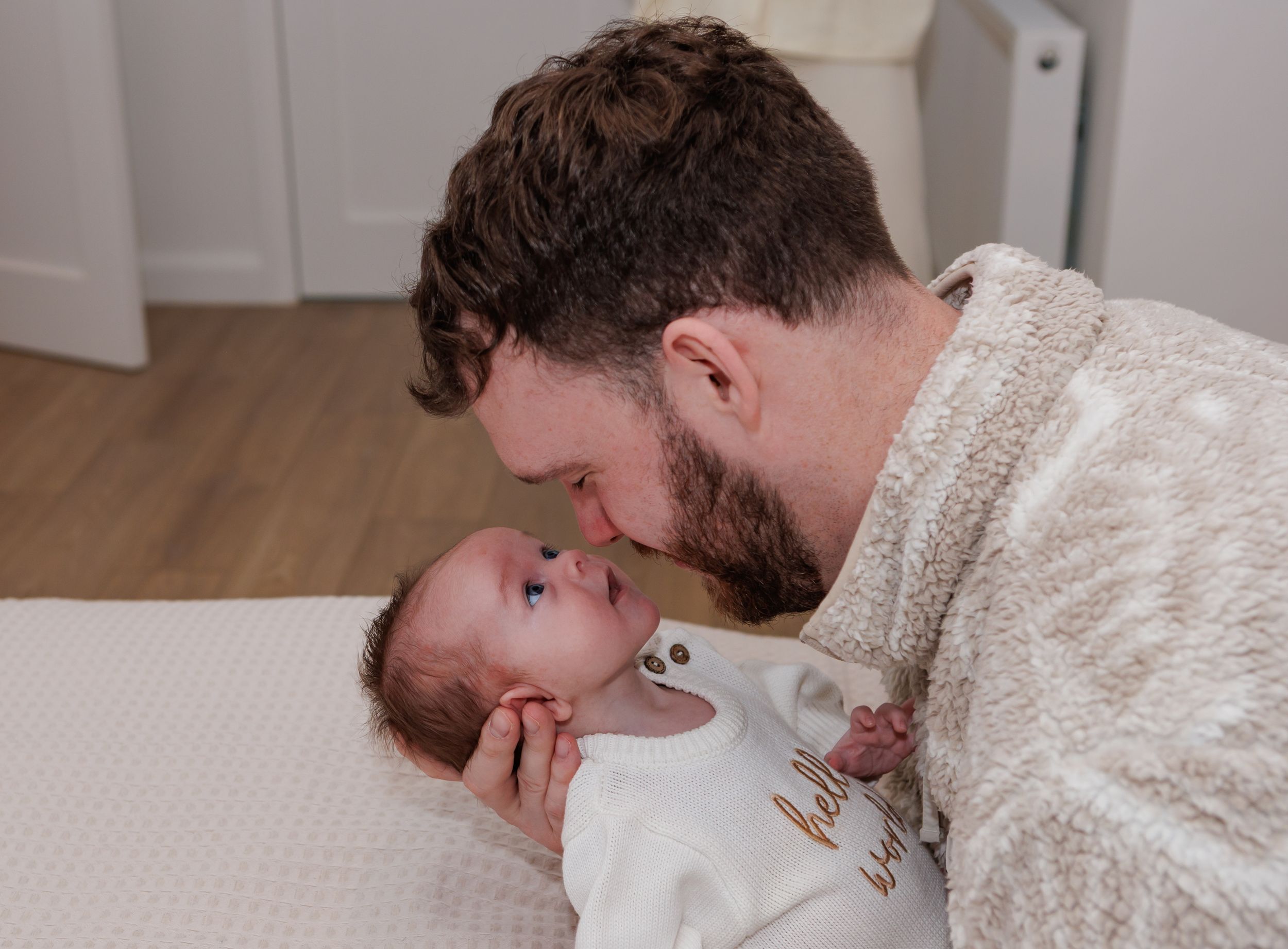 Intimate family moment captured on couch with newborn baby.