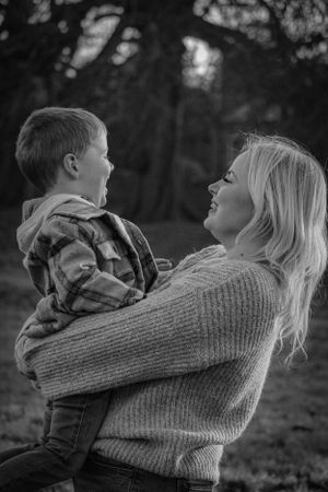 Series of black and white photos showing tender moments between two people in a wooded setting.