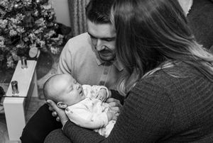 Black and white photo series showing tender family moments with decorative elements in background.