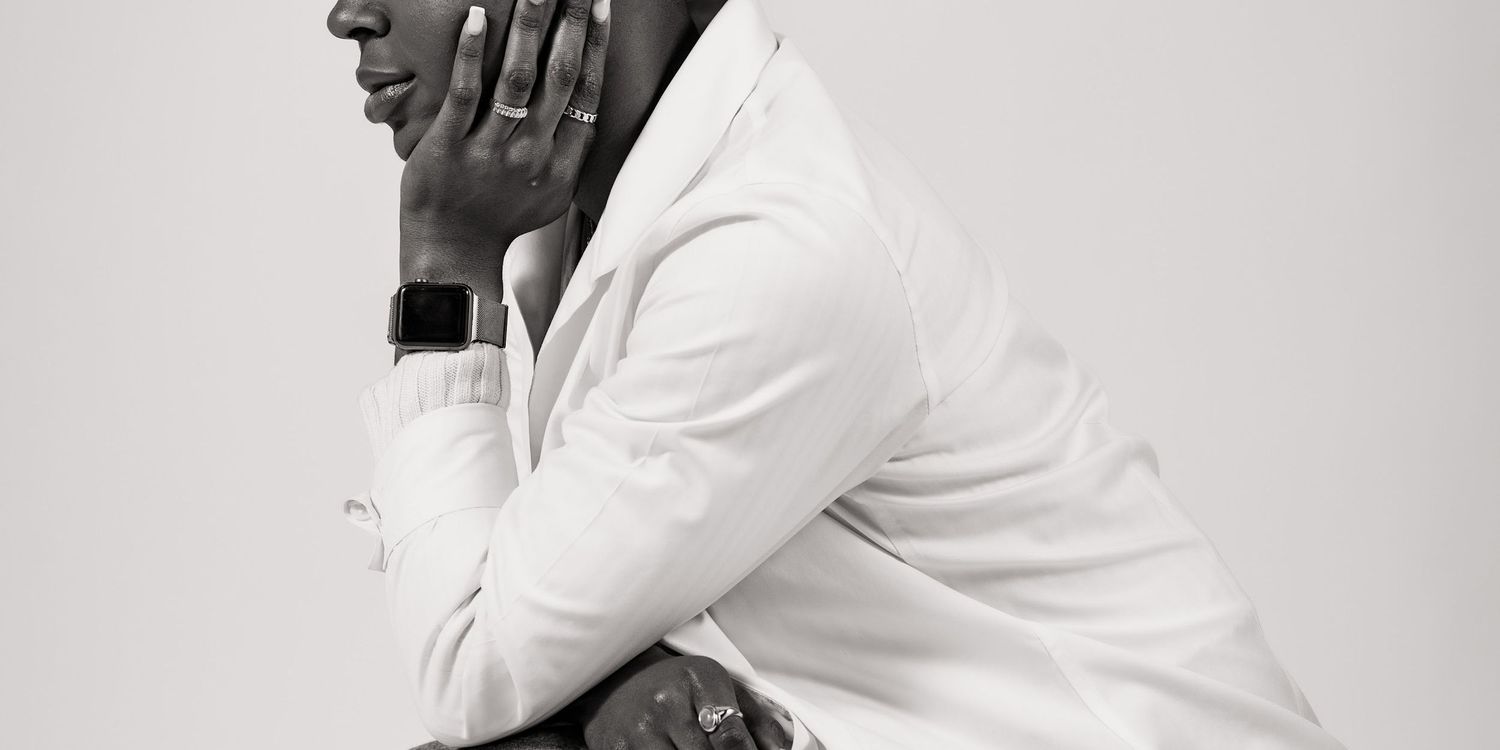 Artistic black and white portrait of someone in a light colored top with a thoughtful expression.