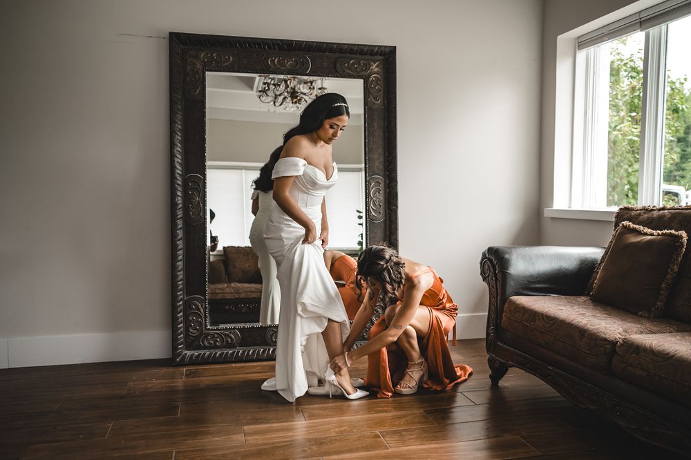 Wedding preparation scene with mirror reflection and dogs sitting nearby.
