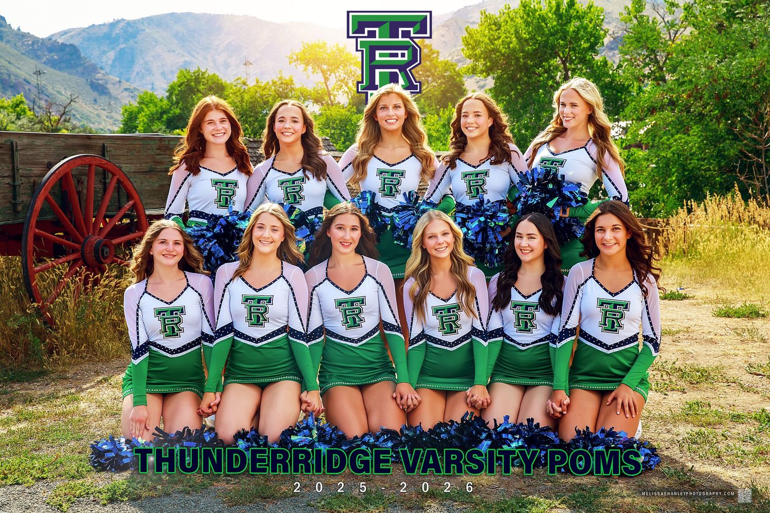 Lightning Strikes cheerleading team photo with blue uniforms and gold pom poms in outdoor setting.