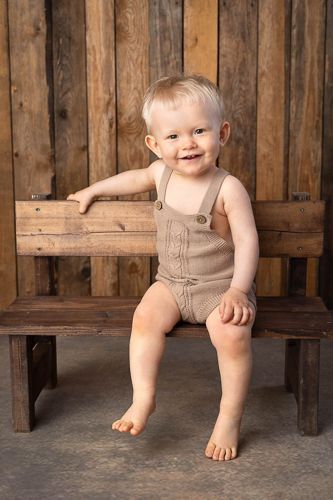 A series of four photos showing a small child's bare feet and legs sitting on a wooden bench against rustic wooden planks.