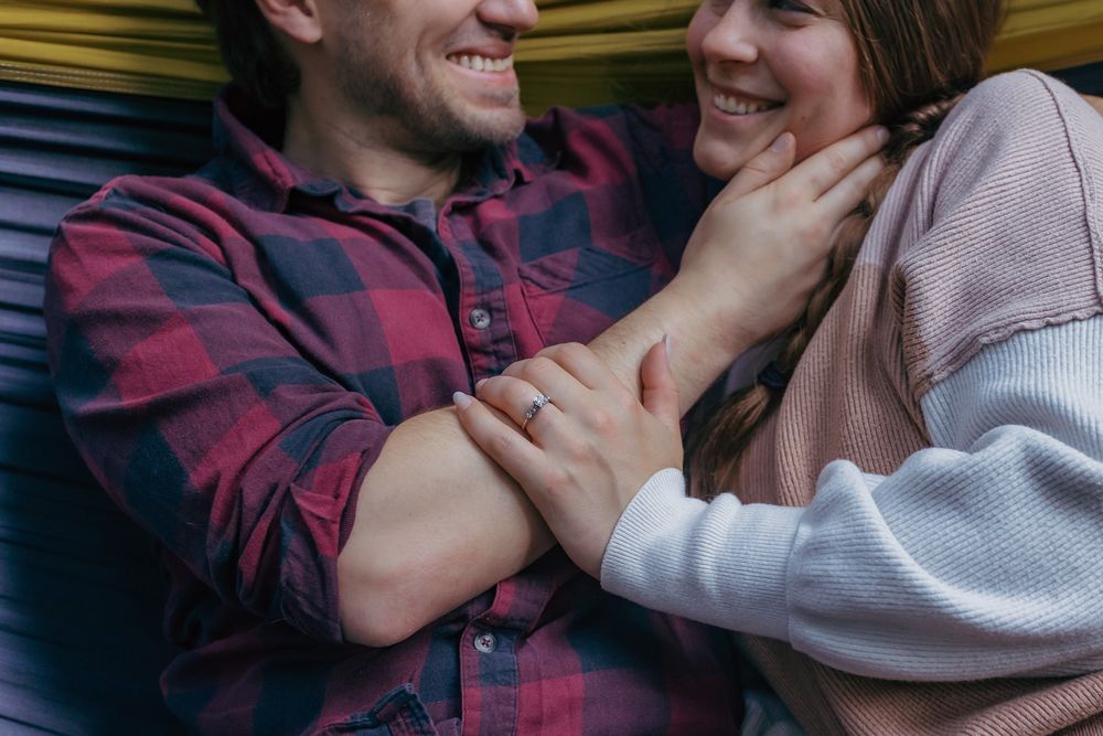Close-up detail photo of an engagement ring while the couple is cuddling during their engagement session in Mosinee, Wisconsin