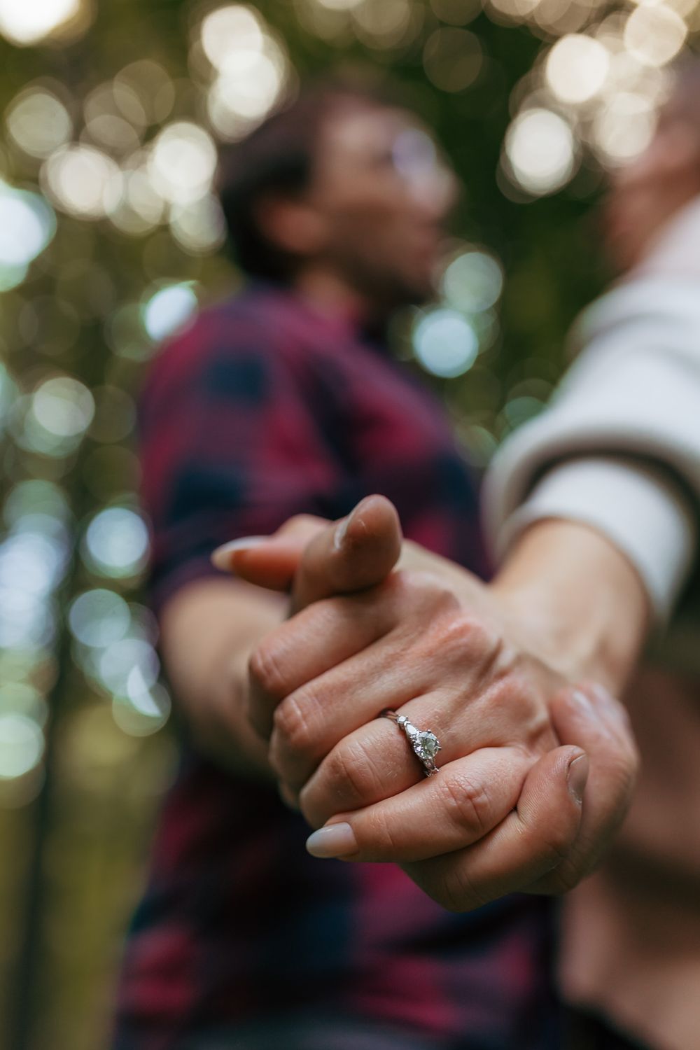 Close-up detail photo of an engagement ring during a romantic engagement session.