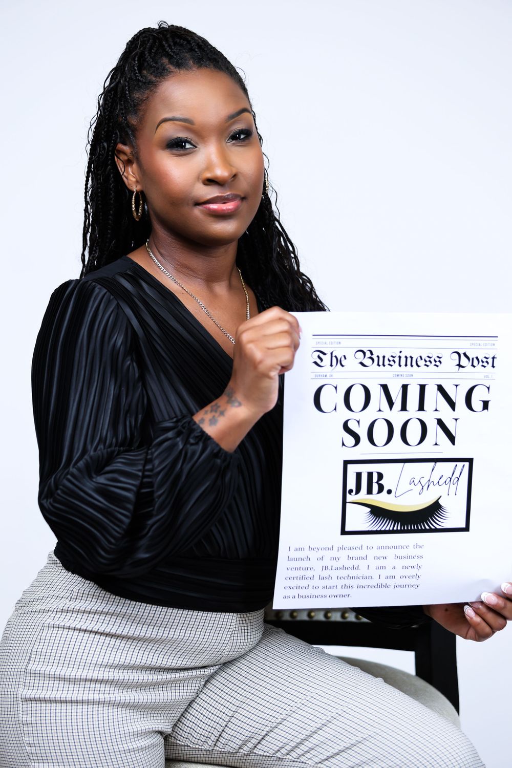 Professional photoshoot featuring person in black top holding 'Coming Soon' business signs.
