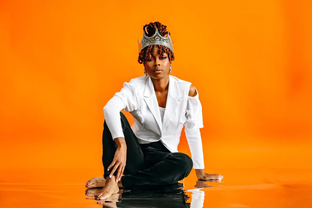 Artistic portrait series against orange background featuring person in white blazer and crown.