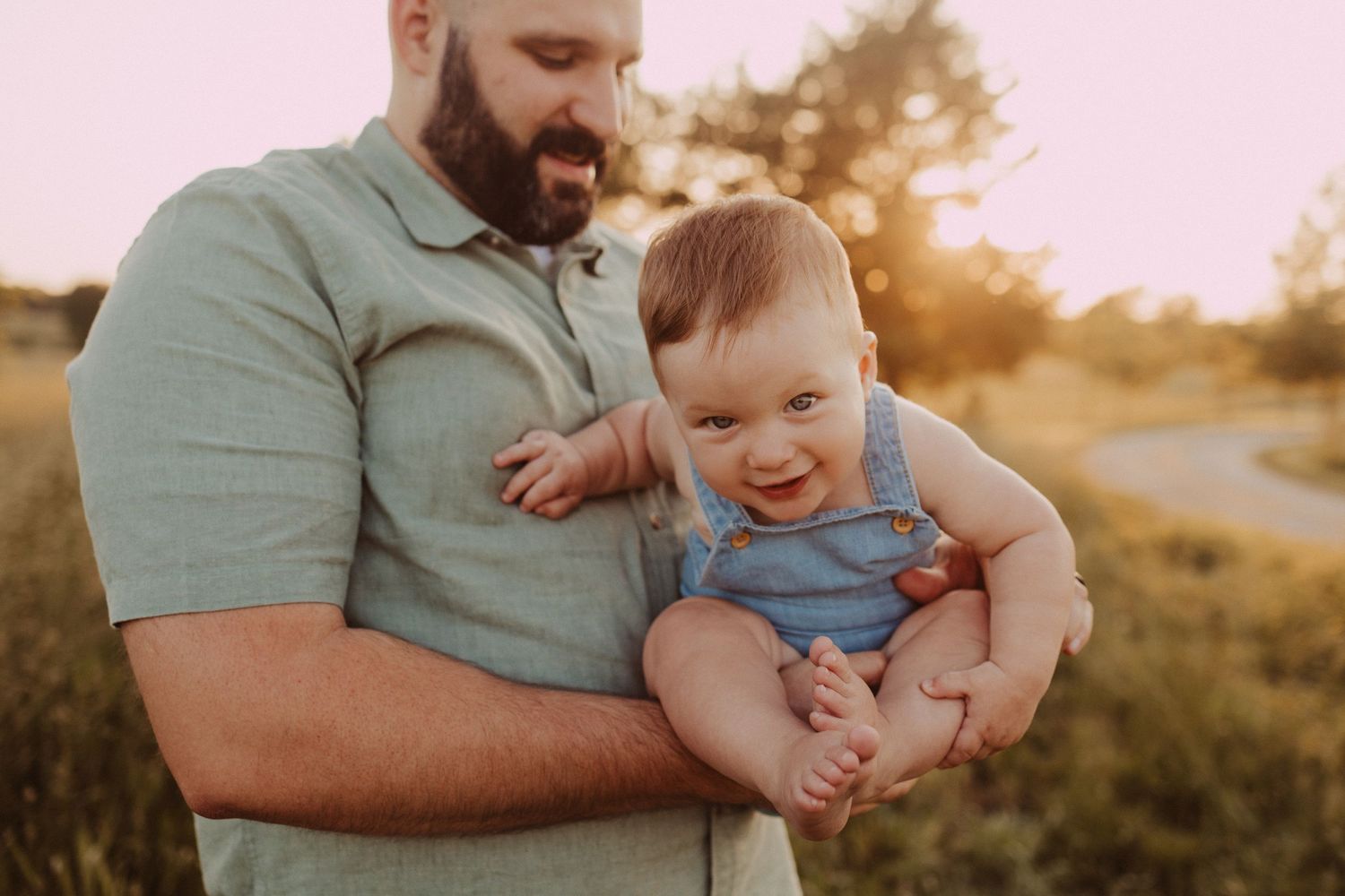 dad hold toddler for outdoor family session