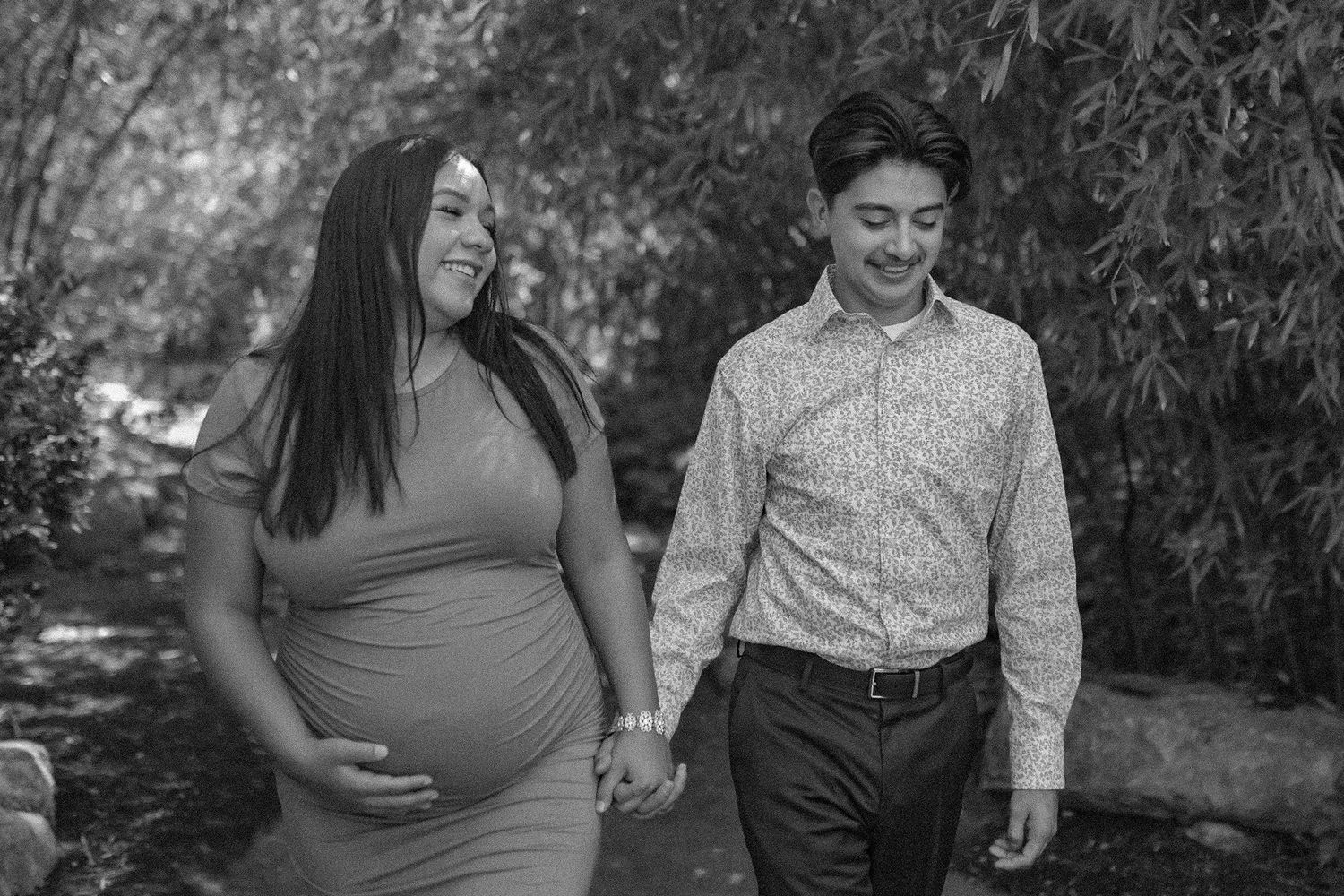 A couple holding hands at the ABQ BioPark botanic garden. Couples photographer albuquerque. Desert elopement photographer. Queer inclusive.