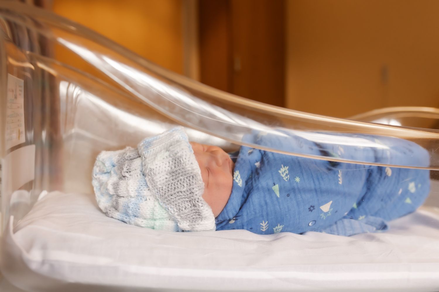 Newborn sleeping in crib for fresh 48 session in central Wisconsin.