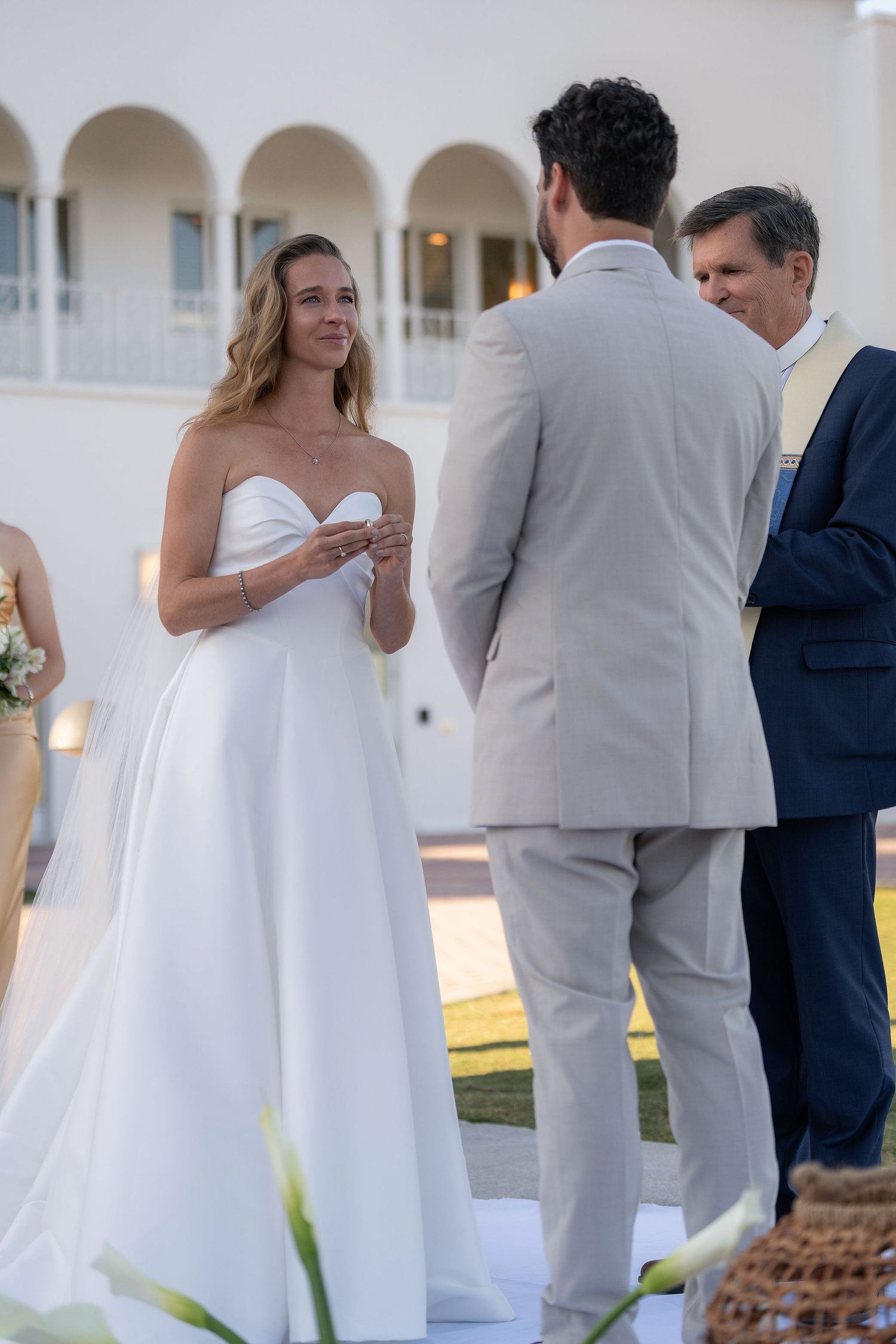 Bride during her vows with the arched loggia of the Mansion at Tuckahoe behind her