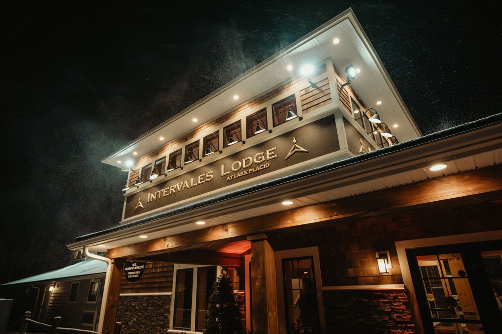 Intervales Lodge illuminated at night with warm lights and festive Christmas tree outside the entrance.