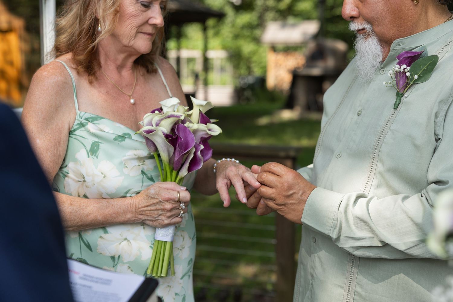 Close-up of Karen and George exchanging wedding rings