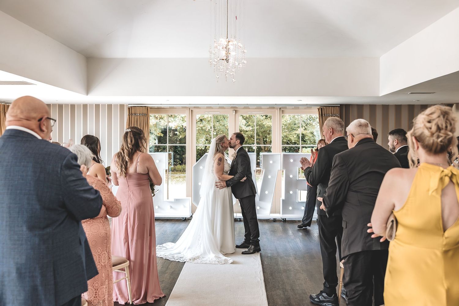 Kelham House wedding ceremony inside the garden room surrounded by family and friends