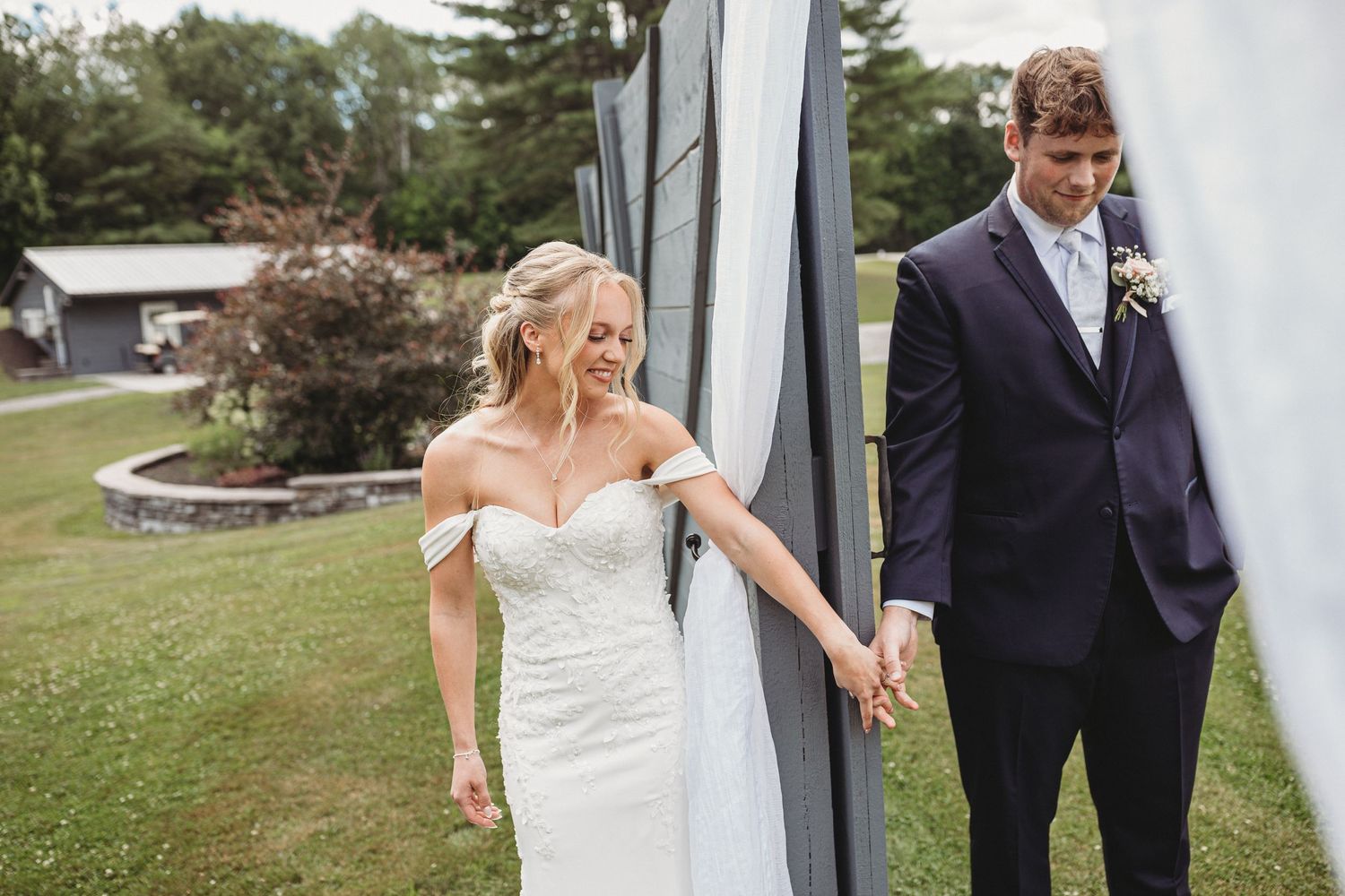 bride and groom doing first touched followed by a private prayer blessing there marriage and the guest at maine wedding