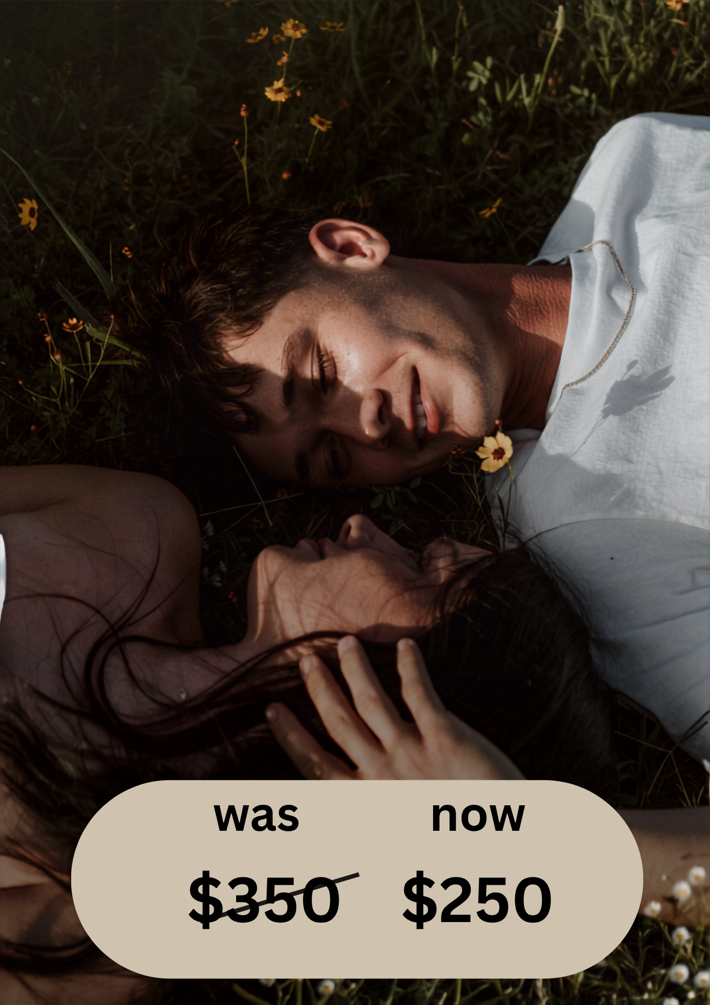 Romantic couple lying in a wildflower meadow, man in white shirt tenderly holding woman close outdoors.
