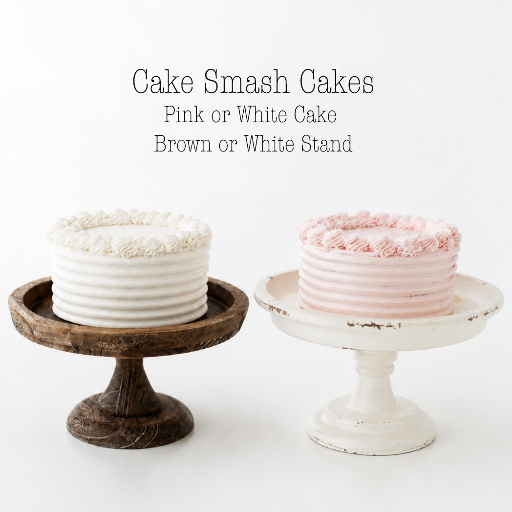 Two elegant cakes on vintage cake stands, one white on wood, one pink on distressed white pedestal, against white background.