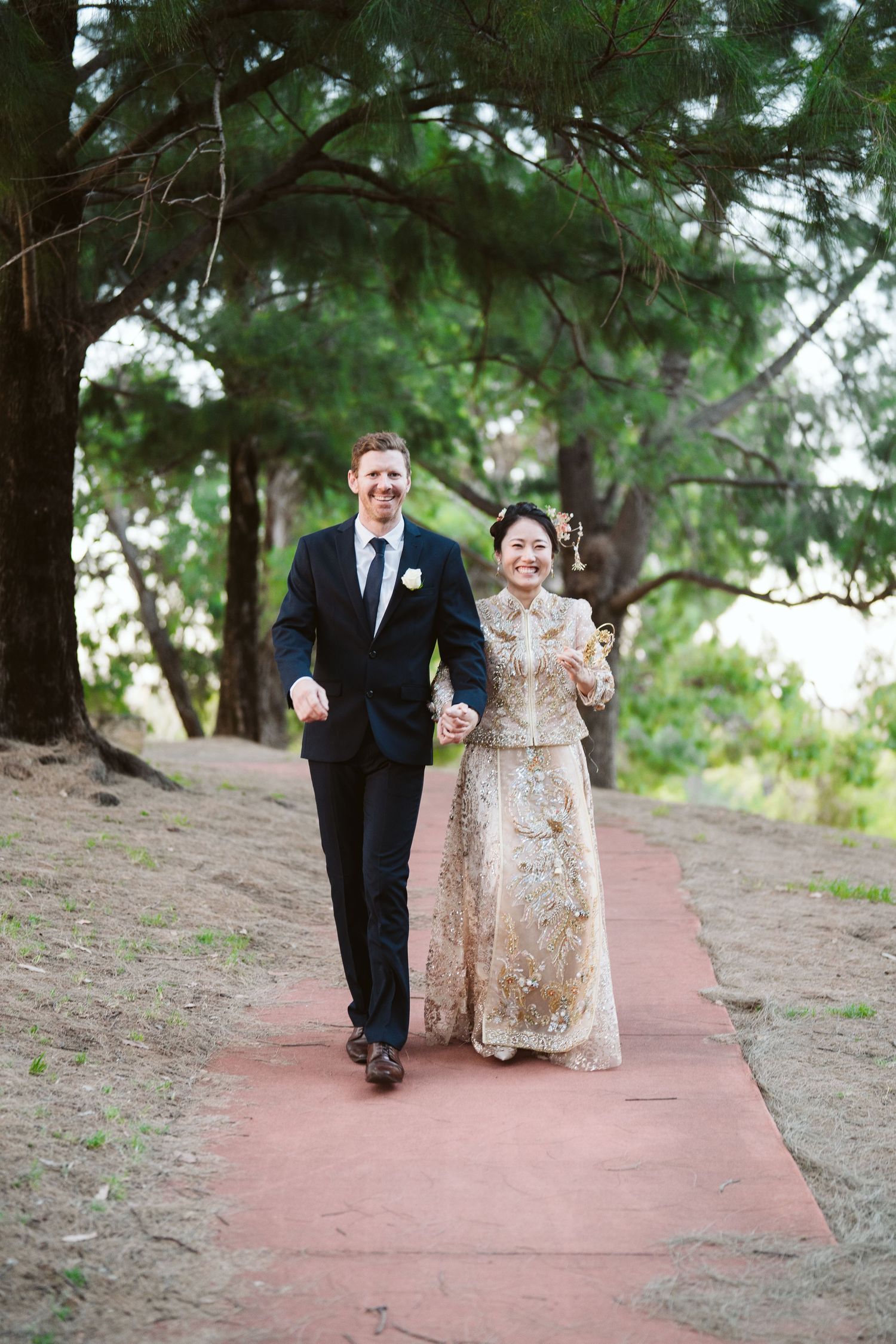Cameron and Lulu walking together down a park path