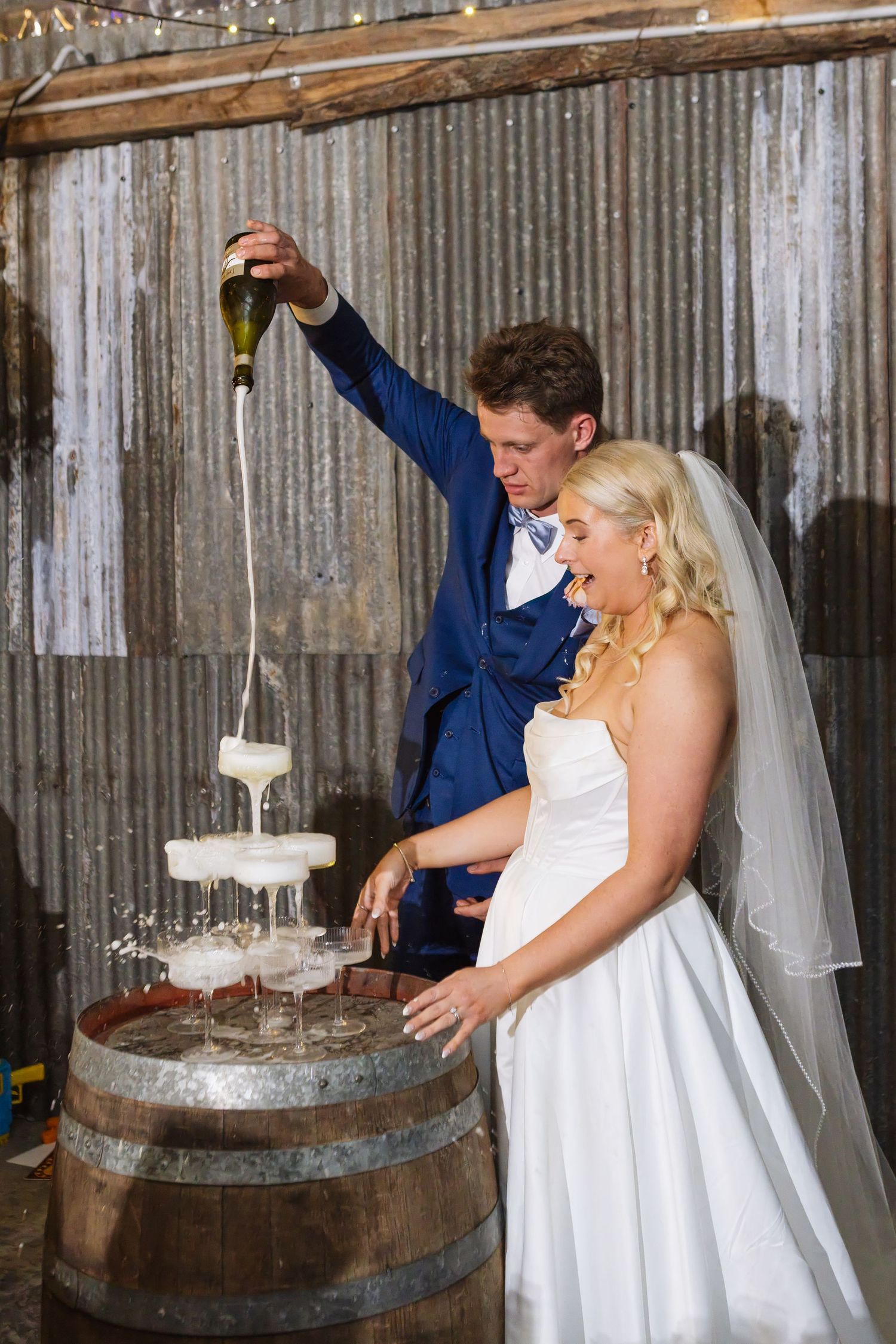Bride and groom during champagne tower pour at Dungog Weddings in the Hunter Valley NSW