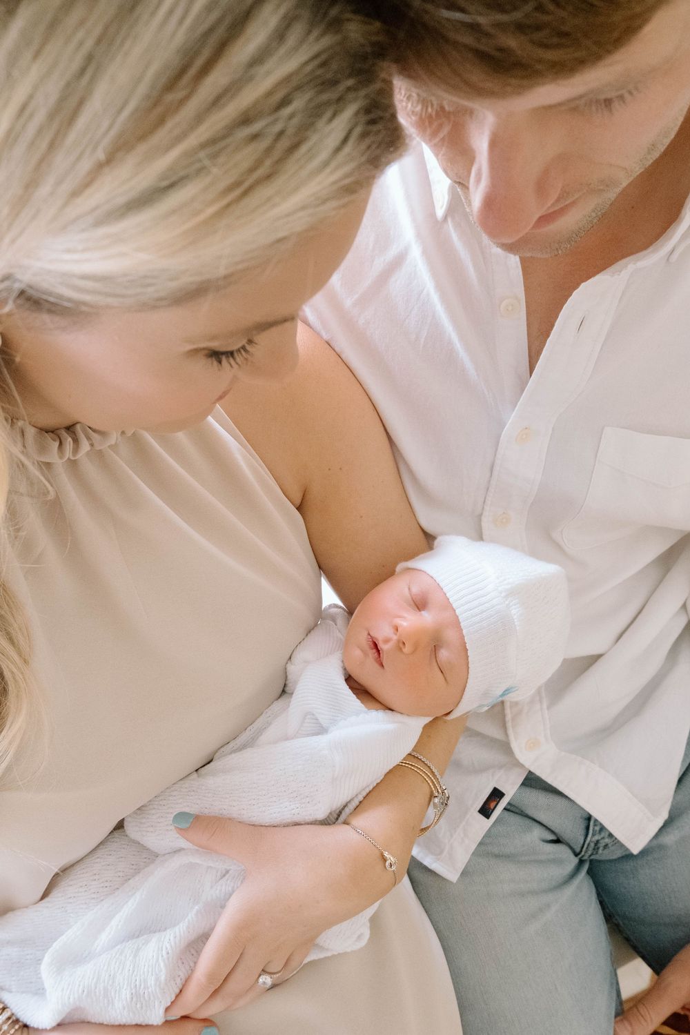Husband and Wife holding baby for a newborn session.