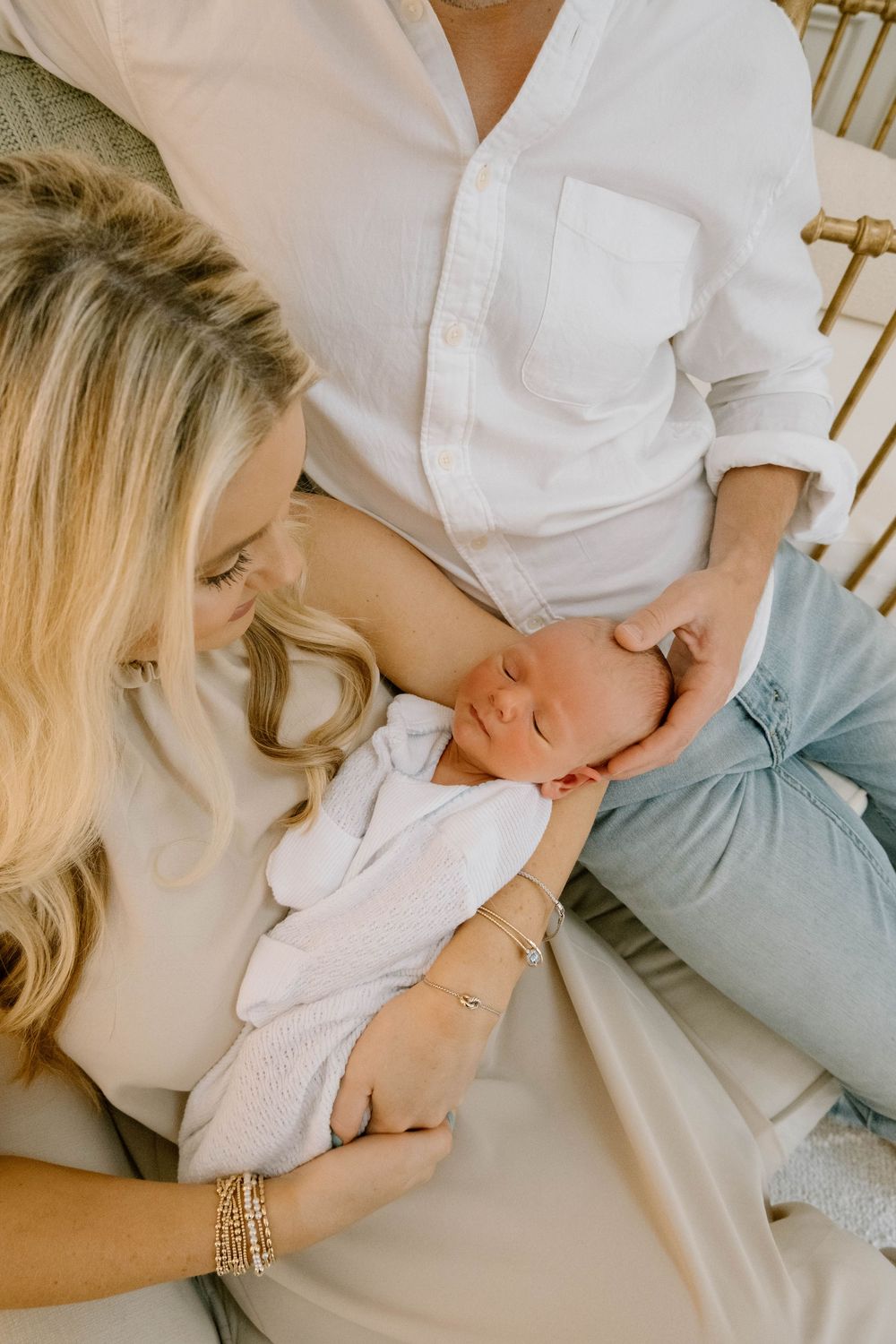 Husband and Wife holding baby for a newborn session.