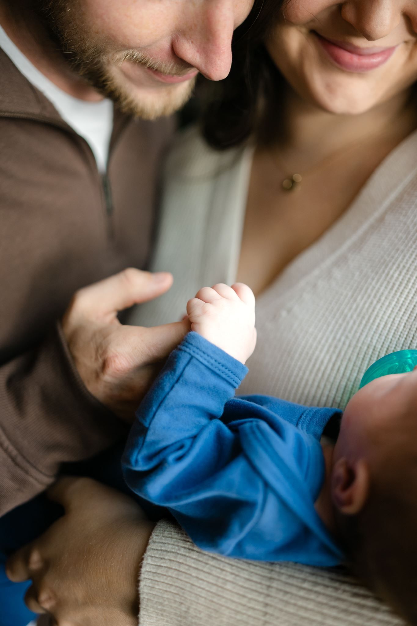 Natural light newborn family photography beside a window inside a Willis Texas home