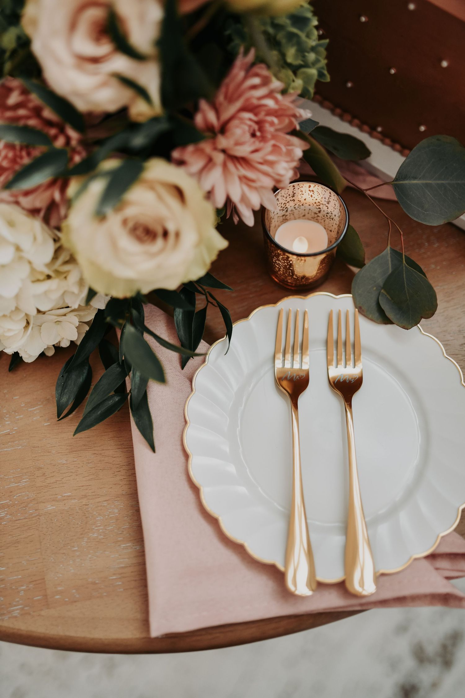 Elegant fall wedding cake featuring delicate floral accents and greenery