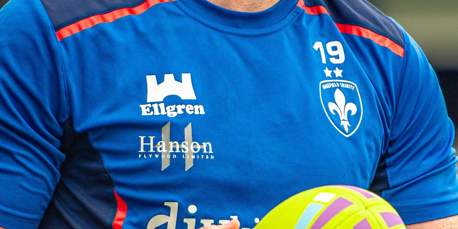Close-up of blue Ellgren Hansen sponsored rugby shirt with number 19 and colorful ball.