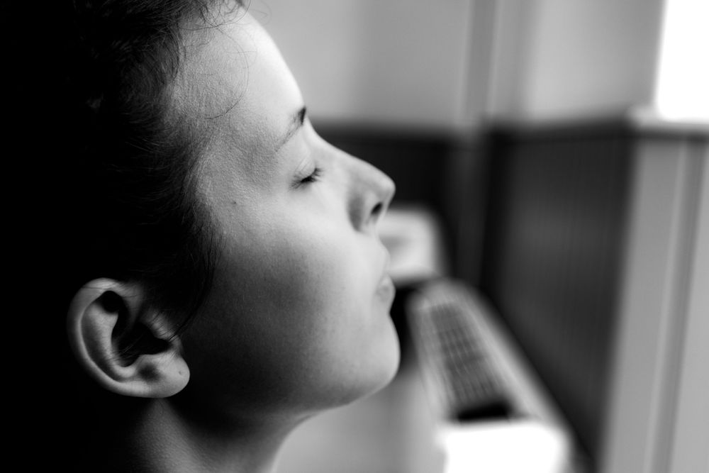 Black and white profile portrait of a young child looking upward with a contemplative expression.