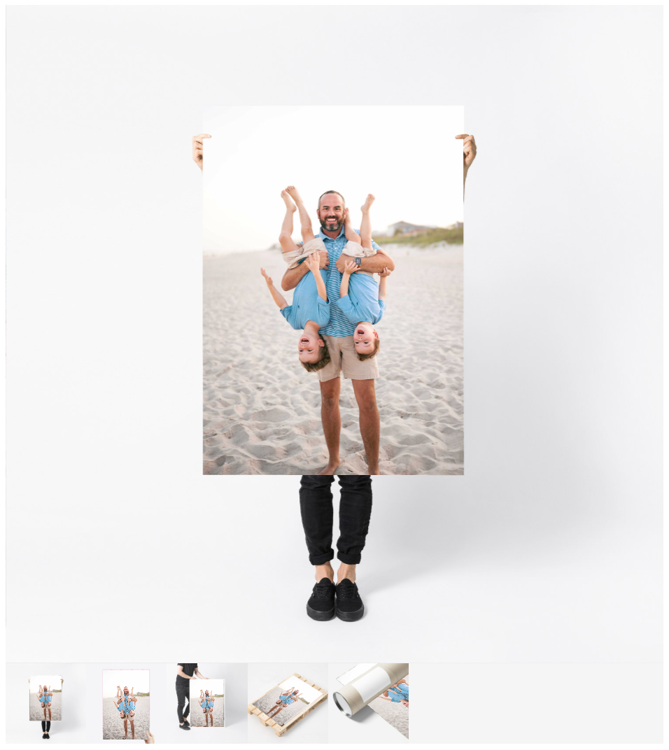 Man holding large beach family portrait print featuring children playfully posed on sandy shore.