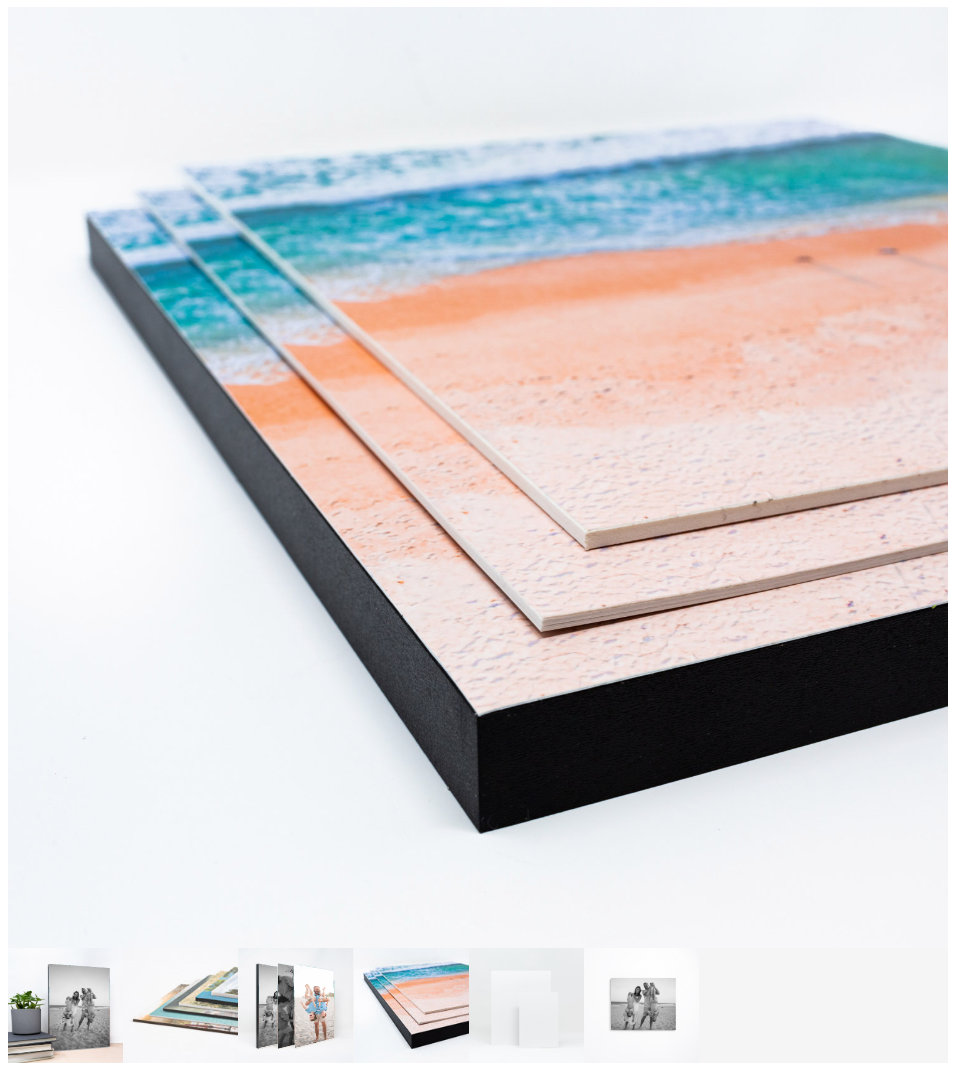 Stacked canvas prints featuring a serene beach scene with turquoise ocean and sandy shore, displayed with black edges.