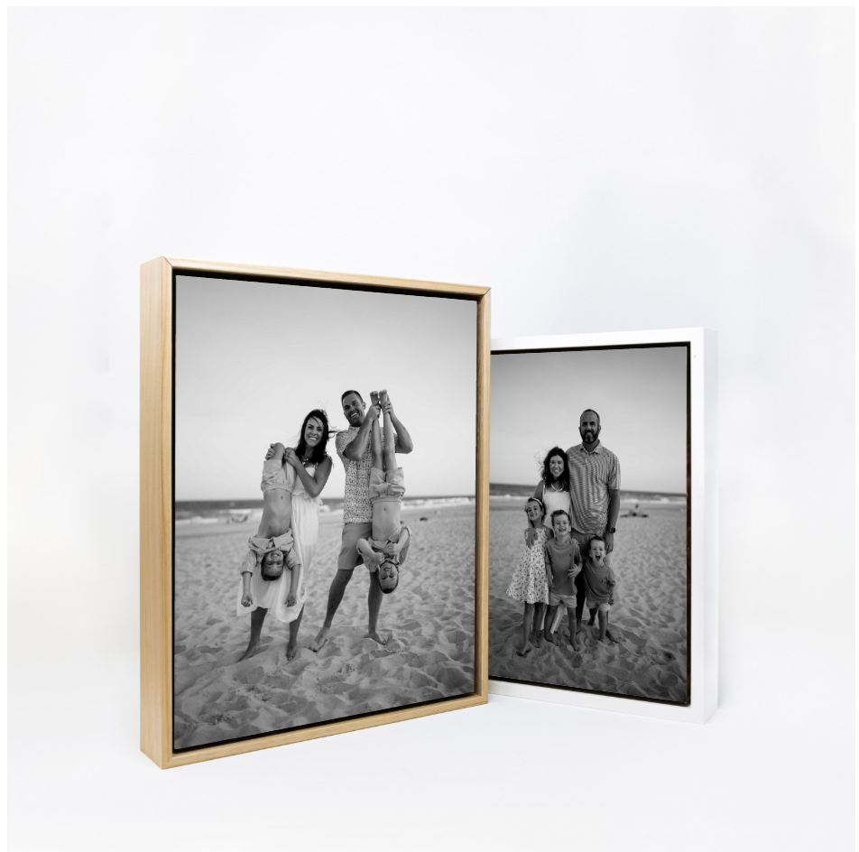 Two black and white family portrait photos displayed in gold and white frames, showing families posing on a beach.