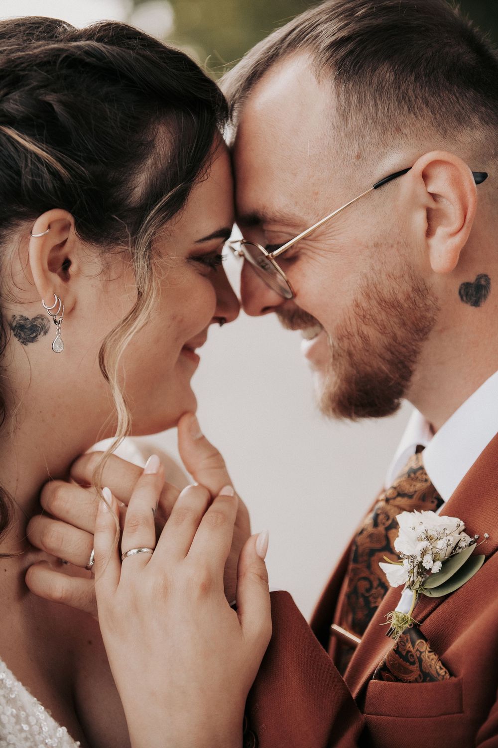 Close-up shots of a couple in rustic wedding attire sharing intimate moments.