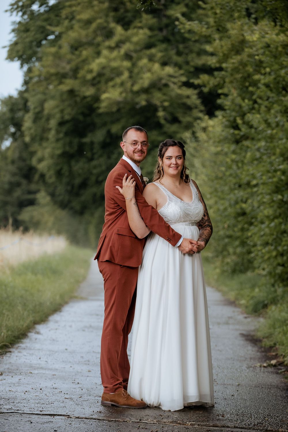Candid wedding photos of a couple on a nature path showing playful interactions.