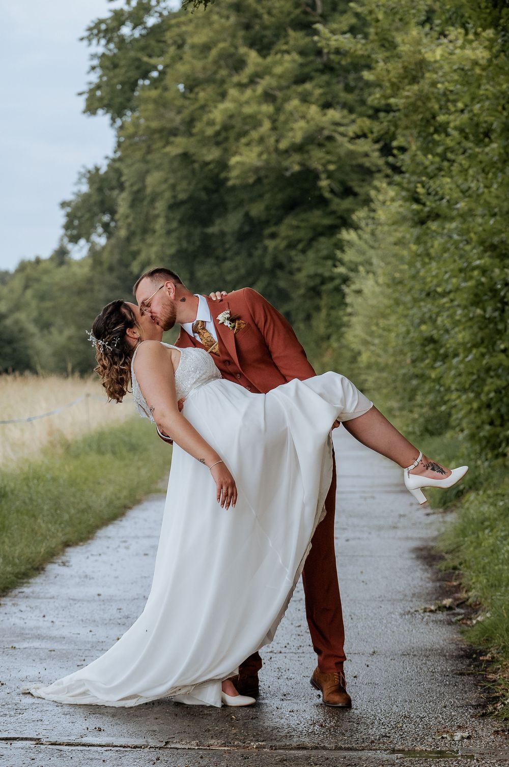 Creative wedding photography sequence showing romantic dip pose on outdoor path.
