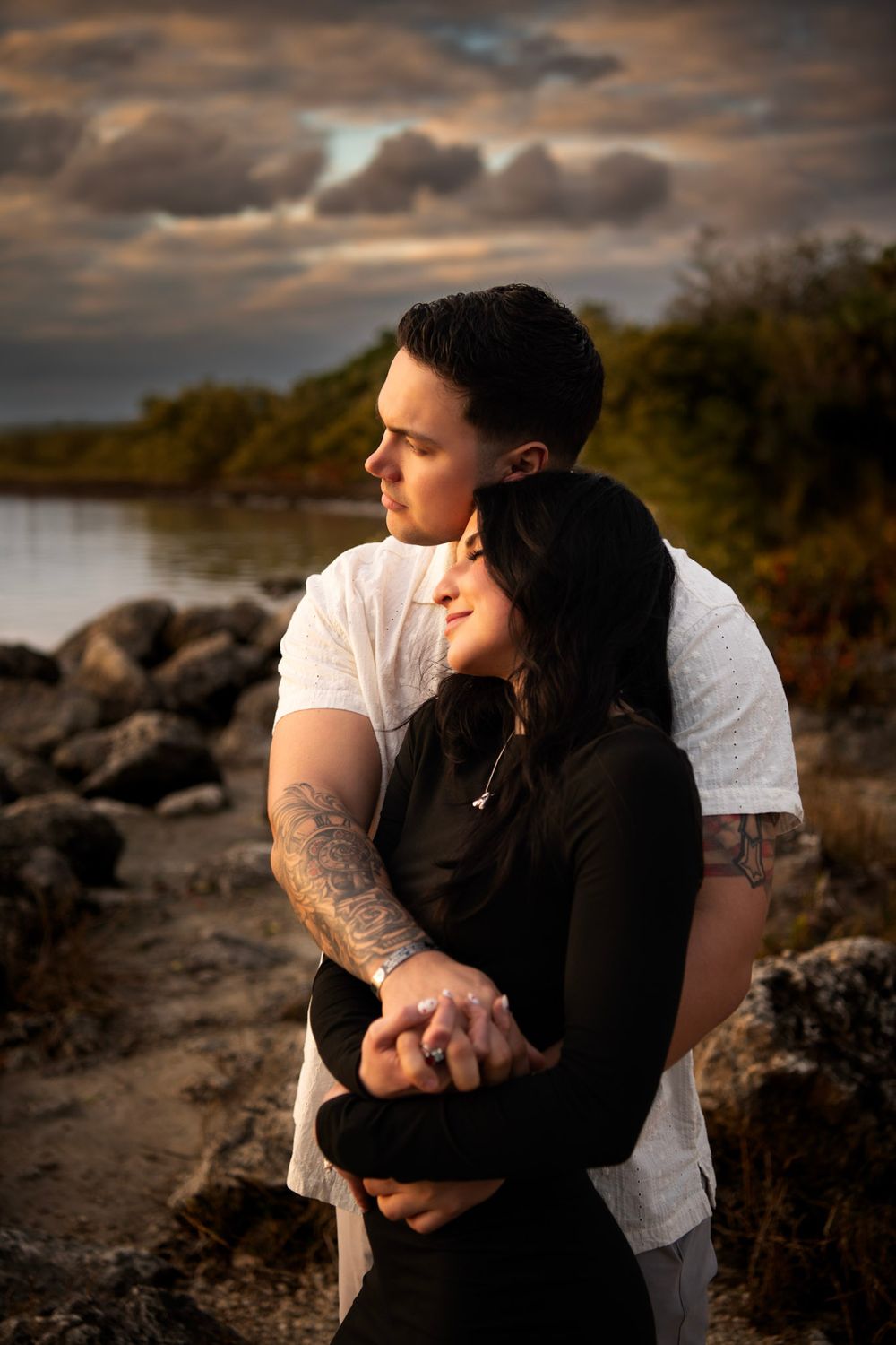 Hands intertwined and hearts full, a newly engaged couple celebrates their next chapter on a Clearwater, FL beach.