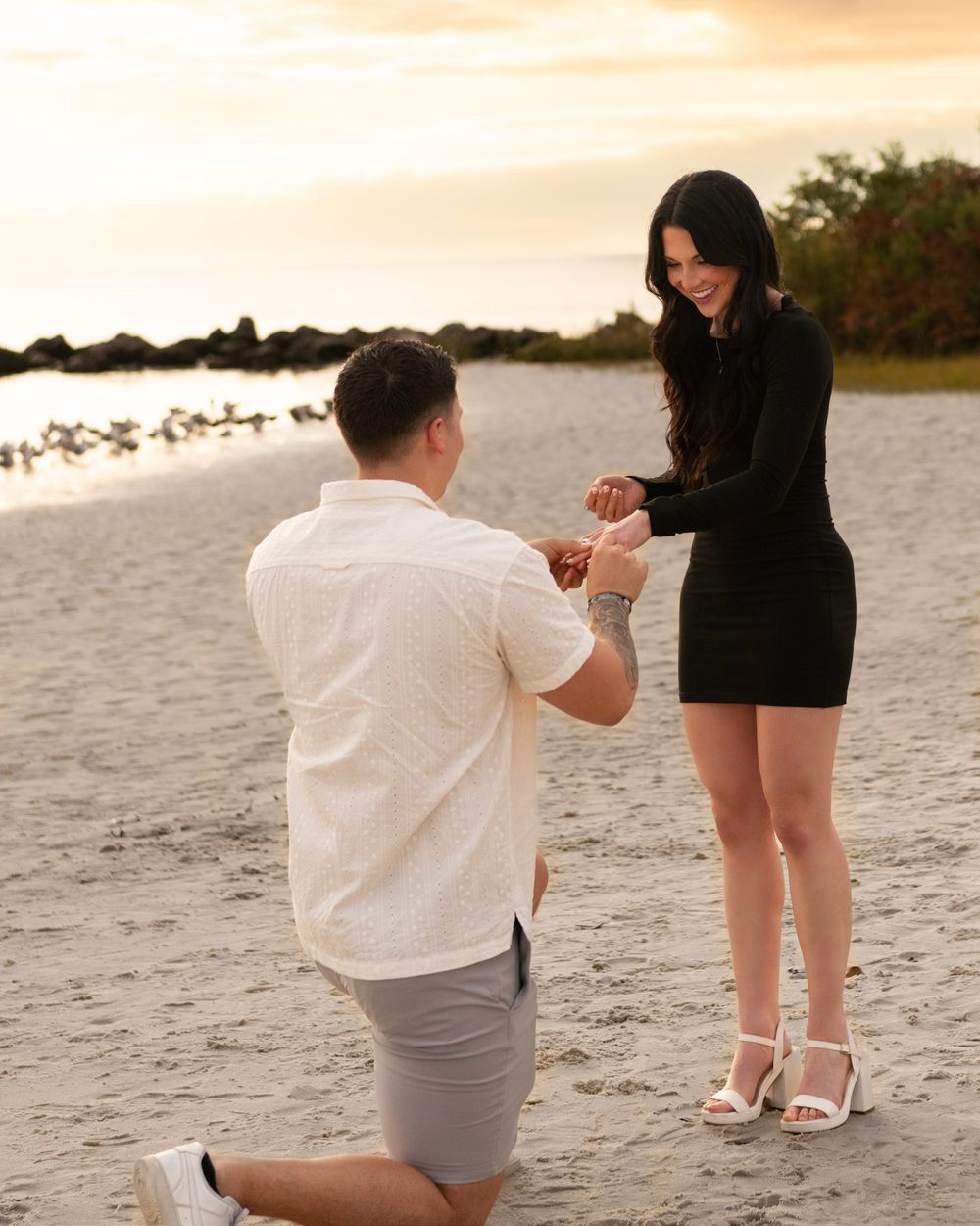 Clearwater FL surprise engagement photos capturing the moment she says yes on a beautiful Gulf Coast beach.
