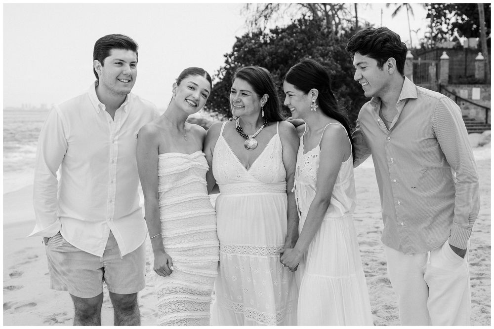Puerto Vallarta Family Photographer captures Candid Family Photos of people laughing together on a sandy beach.