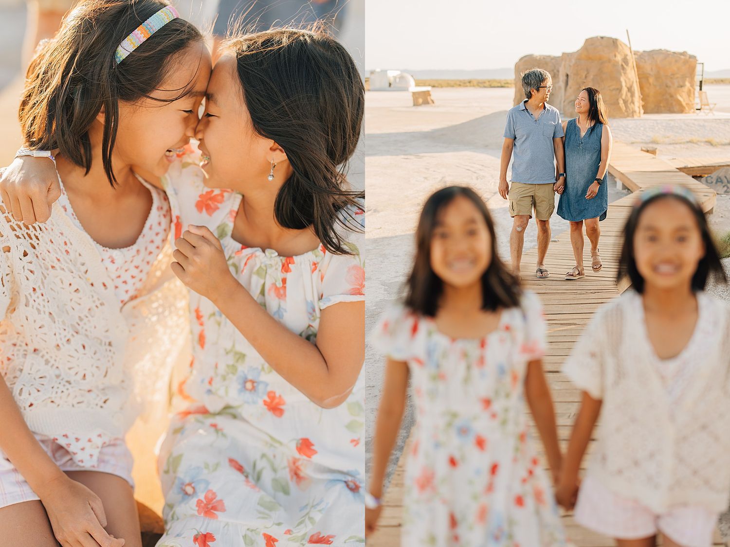 Two sisters share a sweet moment while family poses on a sandy beach in warm golden light.