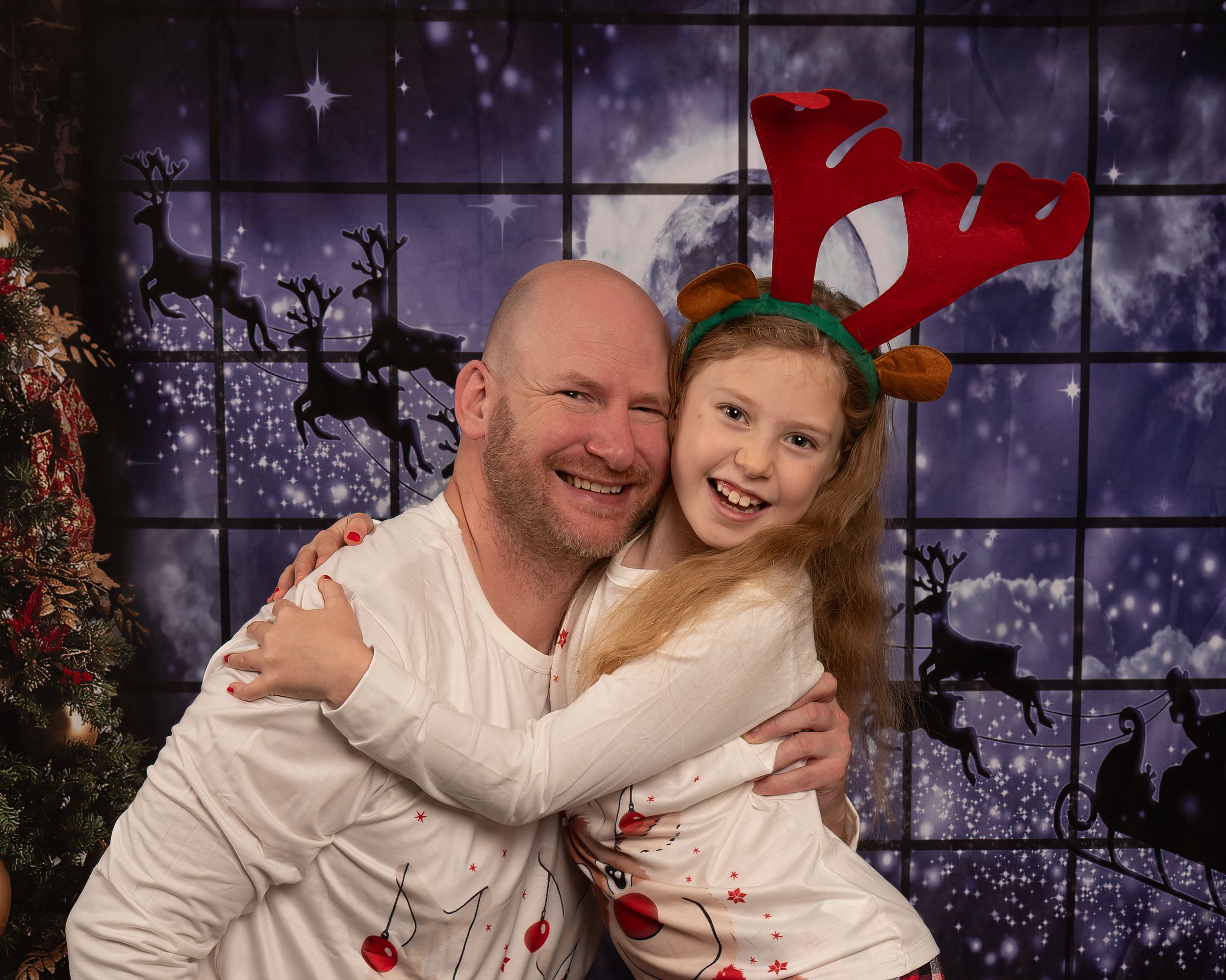 A series of four festive holiday photos showing people embracing and smiling in front of a decorated Christmas backdrop.